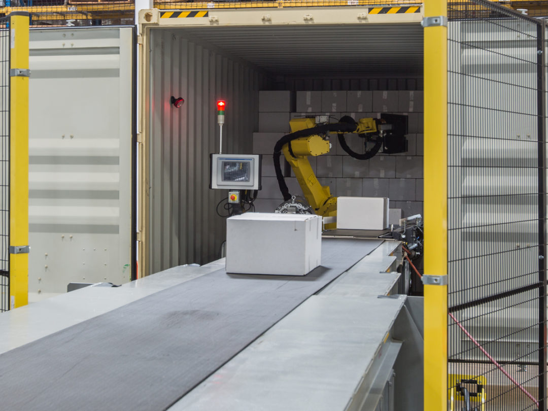 Robotic arm loading truck trailer