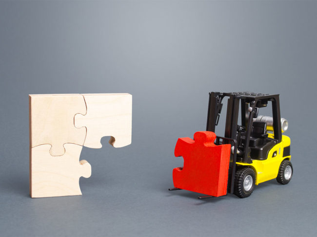 Toy forklift bringing missing puzzle piece to puzzle