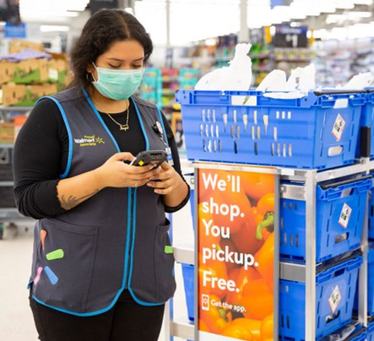 Walmart employee using mobile device in store