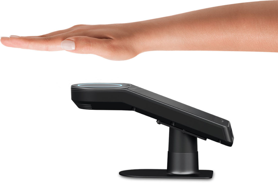 Person holding palm of hand over palm scanner