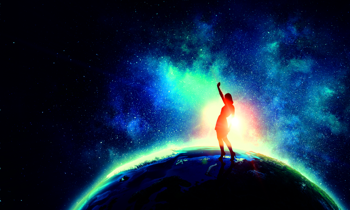 Woman standing on top of world pumping fist