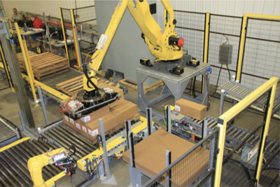 Overhead robotic arm picking up box from conveyor