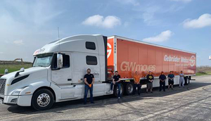 Gebrüder Weiss and Delta Group Logistics employees in front of truck