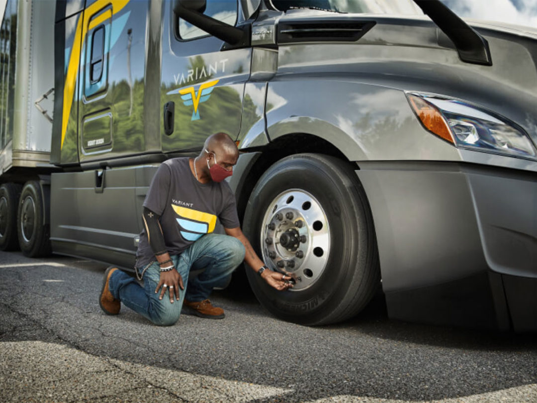 Person checking truck tire