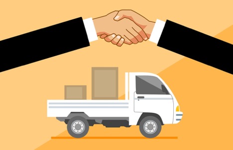 Business people shaking hands above a truck