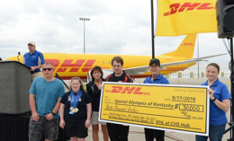 DHL employees with giant check in front of DHL airplane