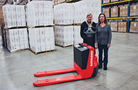 People in warehouse with pallet jack