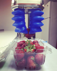 Robotic arm about to grab strawberries